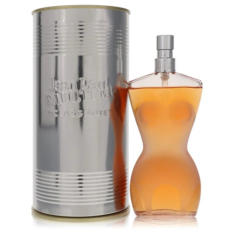 Jean Paul Gaultier perfume bottle and silver canister on a white background