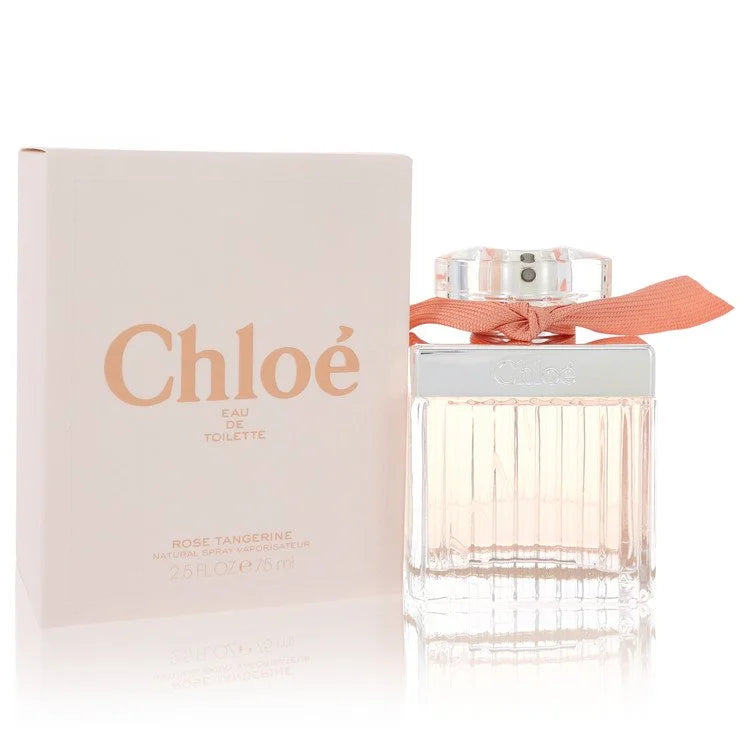 Bottle of Chloé Roses Tangerine Eau de Toilette with rose petals and fresh tangerines in a soft, floral setting 75ml