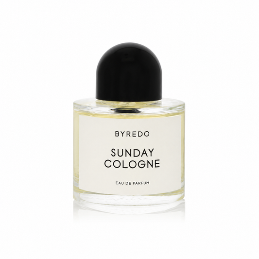 A clear glass bottle of Byredo Sunday Cologne Eau de Parfum with a black dome-shaped cap and a white label, shown on a clean white background.
