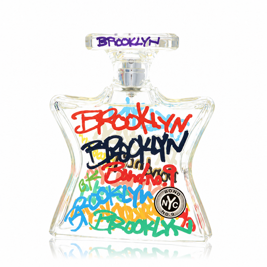 A clear glass Bondo NYC Brooklyn perfume bottle with colorful graffiti-style 'BROOKLYN' lettering in red, black, blue, green, yellow, and purple on a white background.