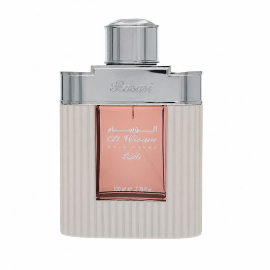 A bottle of Rubaiyat Al Wisam Eau de Parfum with a ribbed off-white body, a metallic silver cap and collar, and a rose gold front label with Arabic and English text.100ml