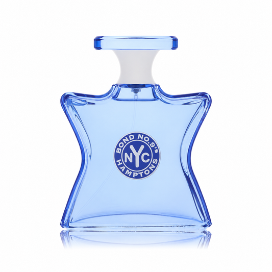 A light blue glass perfume bottle with a white neck and a circular Bond No. 92 Hamptons NYC logo on the front, set against a plain white background with a soft reflection below.