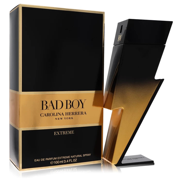 Gold-accented lightning bolt bottle of Carolina Herrera Bad Boy Extreme Eau de Parfum with fiery, smoky background 100ml