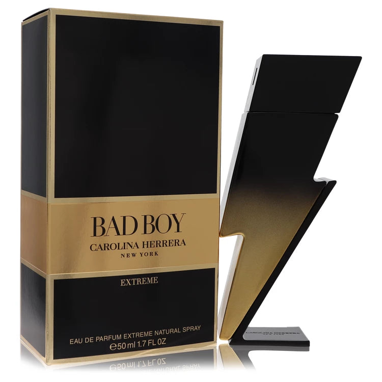 Gold-accented lightning bolt bottle of Carolina Herrera Bad Boy Extreme Eau de Parfum with fiery, smoky background 50ml
