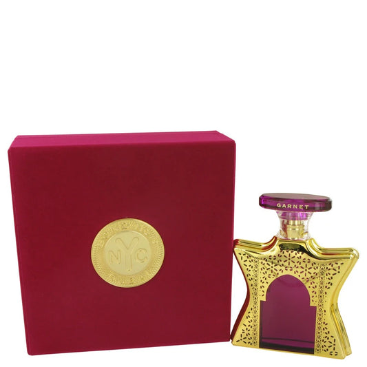 Perfume bottle with gold cap and pink body next to a red box with a gold emblem on a white background 100ml