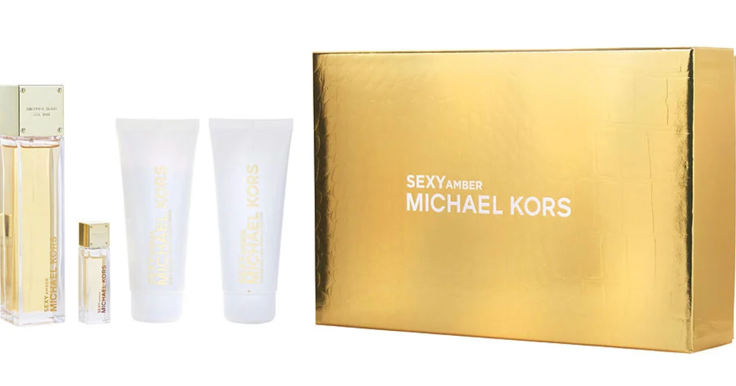 Sexy Amber by Michael Kors Gift Set – 100ml Eau de Parfum, 100ml Shower Gel, 100ml Body Lotion, and 5ml Mini Spray in sleek gold and white packaging.